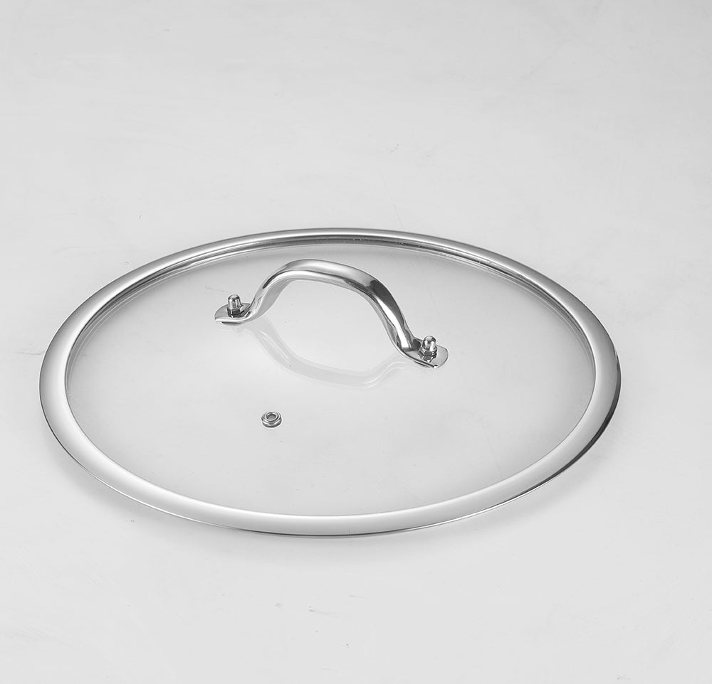 Clear glass pot lid with a silver handle on a light gray background