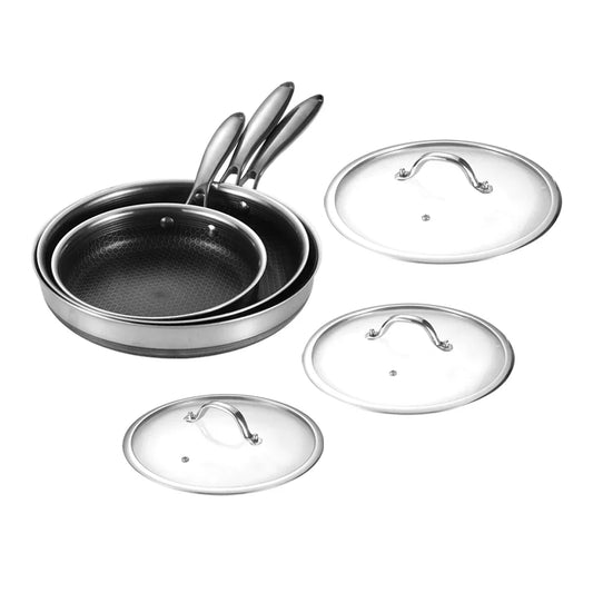 Set of frying pans with glass lids on a white background