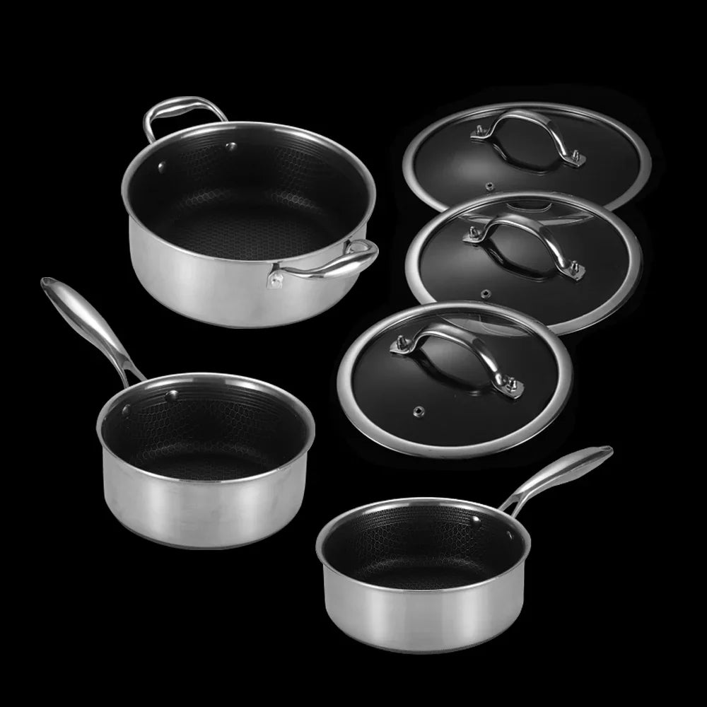 Set of stainless steel cookware with lids on a black background