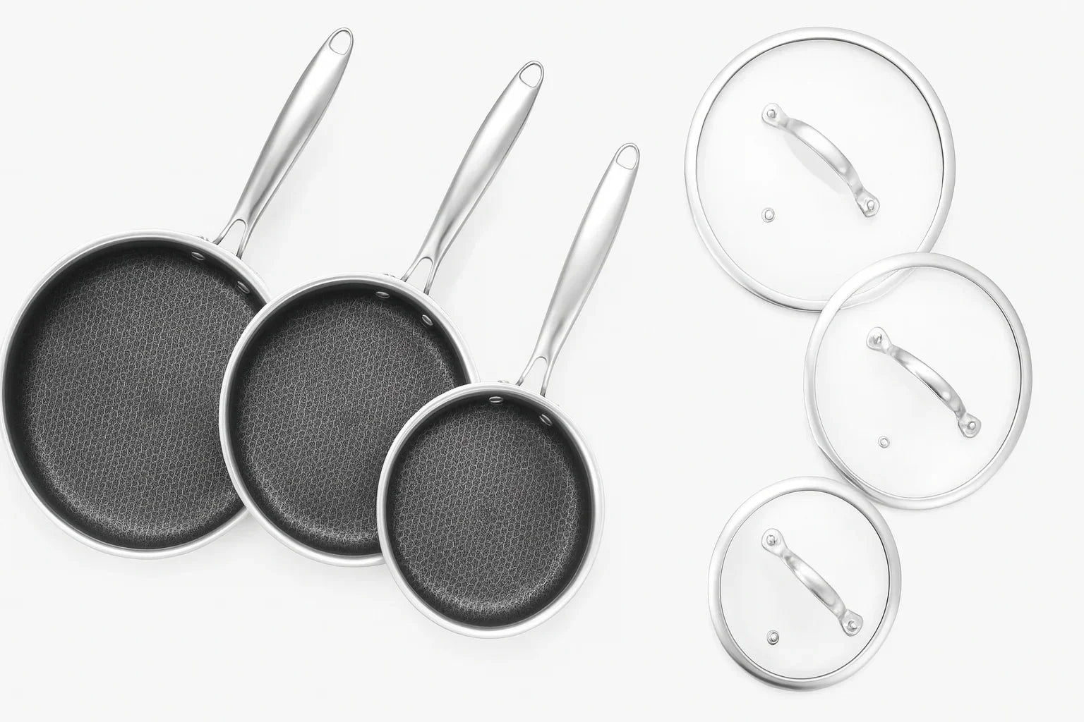 Set of frying pans with matching lids on a white background