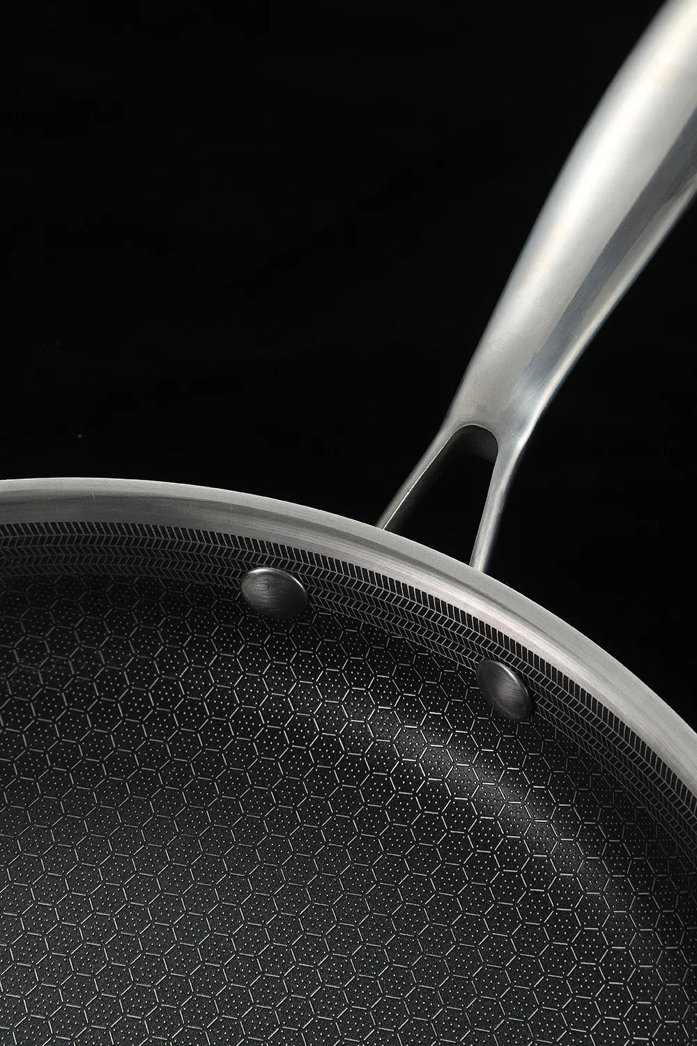 Close-up of a frying pan with a black background