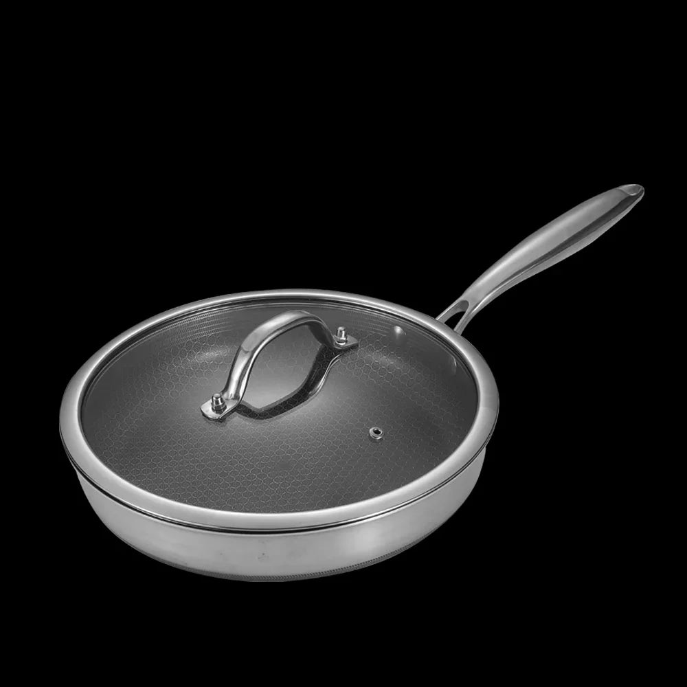 Stainless steel frying pan with lid on a black background